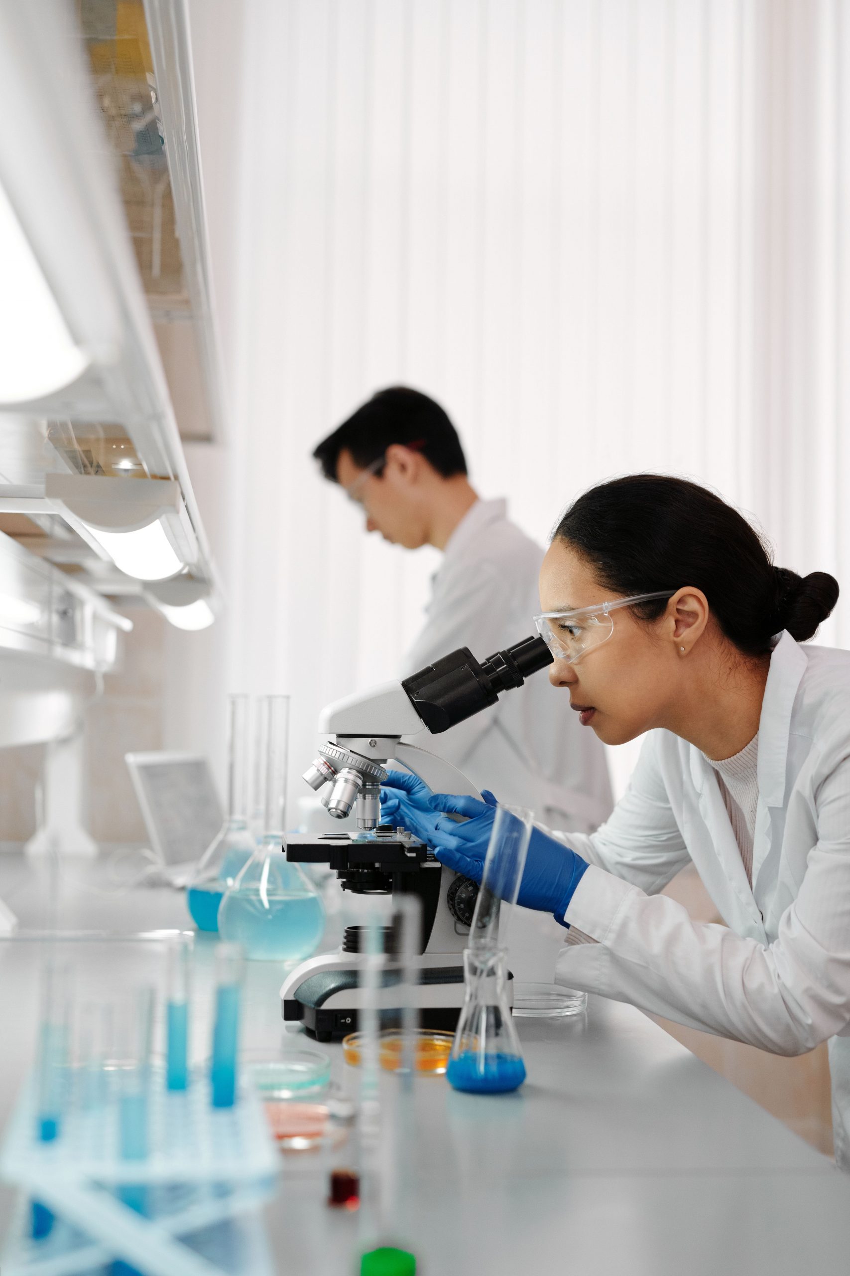 Scientists conducting biotechnology research in a modern laboratory using advanced equipment for medical innovation and genetic analysis.